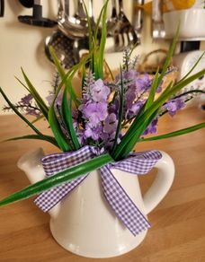 Artifical flowers in jug