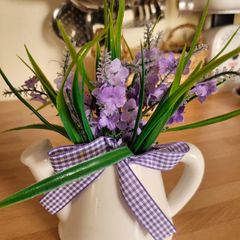 Artifical flowers in jug