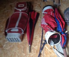 Golf bags and some golf clubs