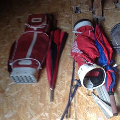 Golf bags and some golf clubs