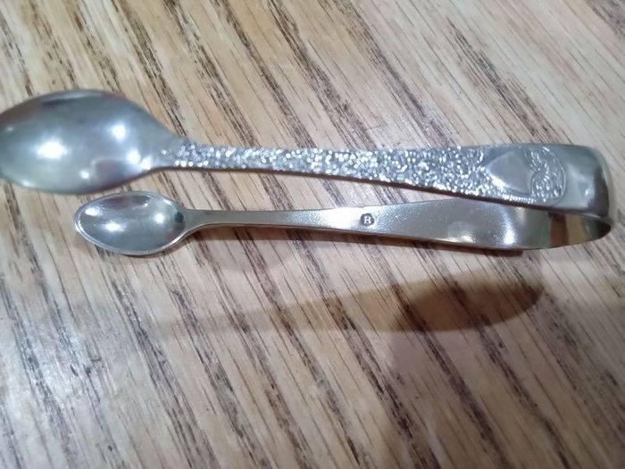 ornate silver sugar tongs