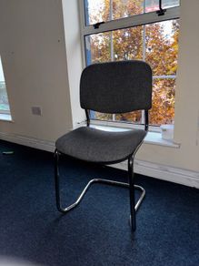 Grey fabric visitor chair with metal frame