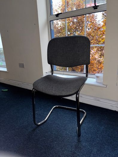 Grey fabric visitor chair with metal frame