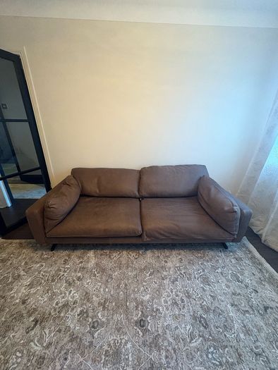 Leather sofa with original harvey Norman tag still attached