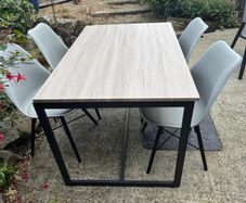 Dinning table which is slightly damaged & 4 new chairs unused