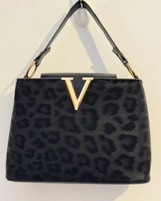 Black leopard print handbag with gold hardware