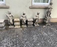 Four stone garden statues