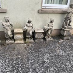 Four stone garden statues