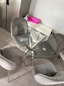 Glass dining table and 4 grey suede chairs