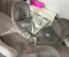 Glass dining table and 4 grey suede chairs