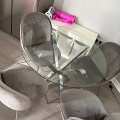 Glass dining table and 4 grey suede chairs