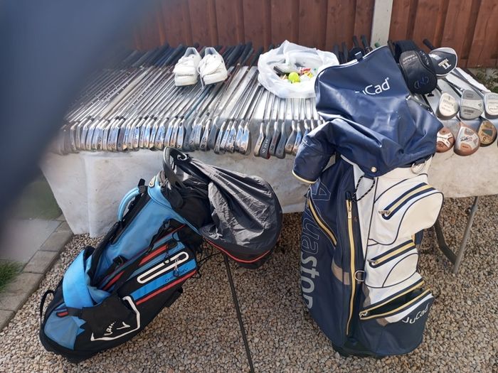 A selection of golf clubs and bags. All right handed clubs.