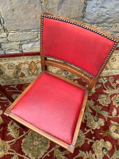 A pair of mid century leatherette kitchen chairs.