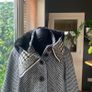 black and white short jacket with detachable faux fur scarf detail and cape sleeves. Image 4