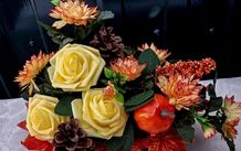 Autumnal artificial flower arrangement with roses and pumpkin