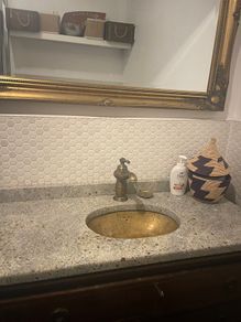 Bathroom sink, tap, drawers and mirror.