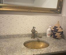 Bathroom sink, tap, drawers and mirror.