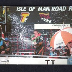 2001 Isle of Man 33 unit / GB3 Isle of Man TT Festival 2000 - Road Racing Capital of the World. Champagne flows for Ian Simpson after winning the Formula 1 race. ((Siemens - S30 (Module 34))) Phone Card
