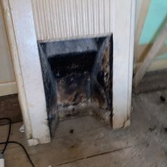 Cast iron fireplace with cream speckled enamel finish.