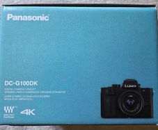 Panasonic Lumix G100D MFT mirrorless camera kit with 12-32mm lens, spare battery, and a Type-C travel charger