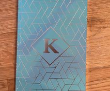 K notebook with lined pages
