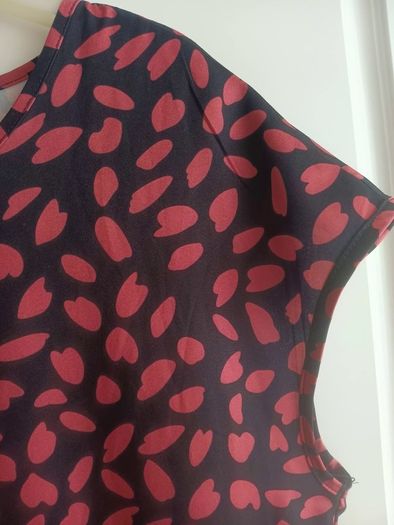 A-line tiered dress with red and black print.