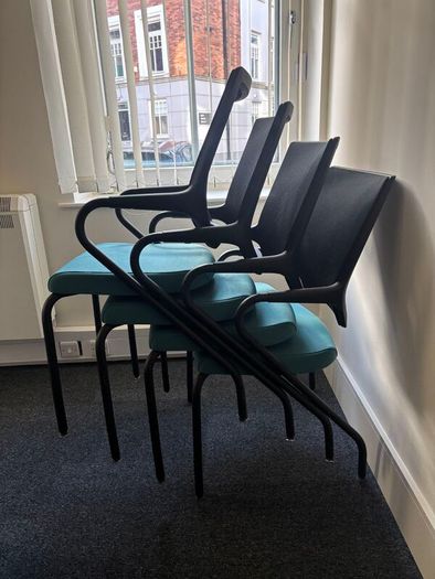 Office chairs with black frames and teal seats