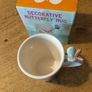 Butterfly Shaped Handle Ceramic Mug, decorated with various colorful butterfly graphics. 3D ceramic butterfly molded directly onto the handle. New in Box. Image 2