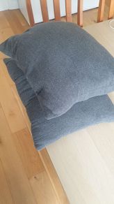 Two grey square cushions