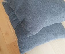 Two grey square cushions