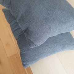 Two grey square cushions
