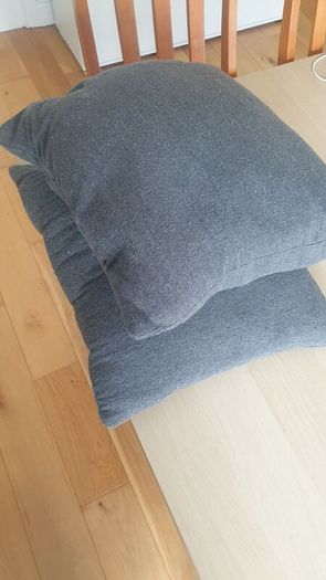 Two grey square cushions