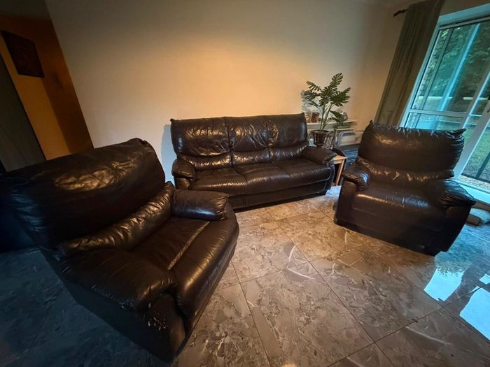 black leather sofa and arm chairs