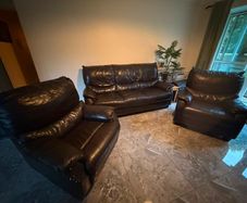 black leather sofa and arm chairs