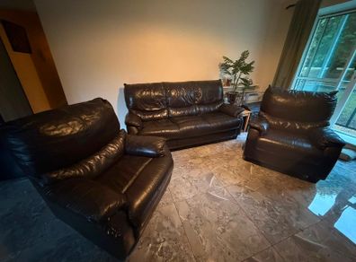 black leather sofa and arm chairs
