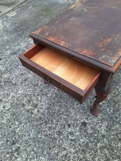 Antique wooden coffee table in need of restoration