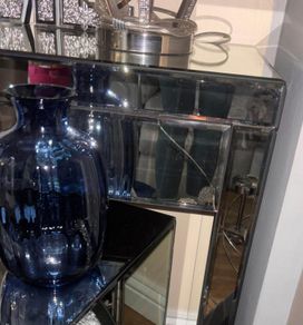 Mirrored furniture with navy velvet accessories
