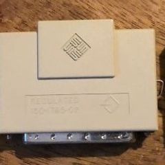 The Sun Microsystems 150-1785-02 SCSI Terminator features two pinch latches, a 50-pin SCSI connector, and an indicator LED