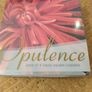 set of four Opulence brand square coasters featuring a vibrant red dahlia flower design. New in Package. Image 3