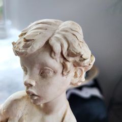 Figure of boy posing with Fish