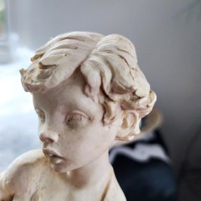 Figure of boy posing with Fish
