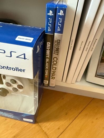 PS4 console with dual shock 4 controller and two COD games