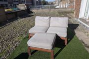 Wooden outdoor lounger with cushions
