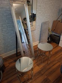 two glass tadles and large mirror