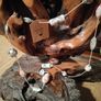 This handmade necklace features a combination of ceramic floral beads and silver-toned metal beads on a pink cord. Image 4