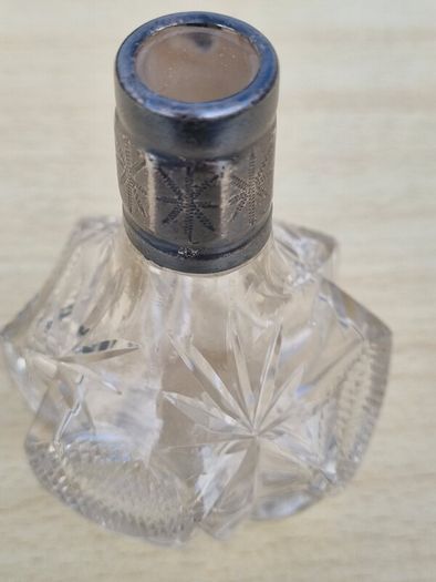 Vintage crystal bottle with silver top