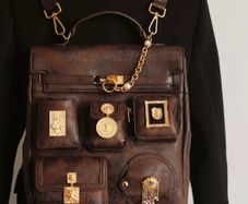 Vintage inspired dark brown backpack with antique gold details
