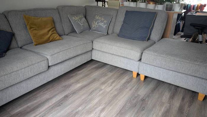 Gray fabric corner chase sofa with footstool