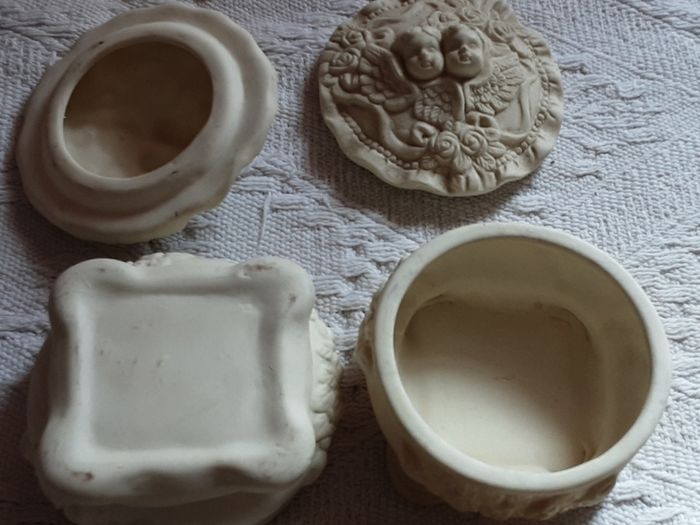 two vintage cherub pots with lids
