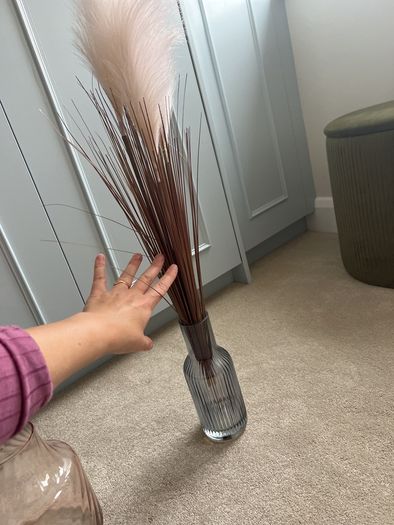 blue glass vase with fluffy reeds